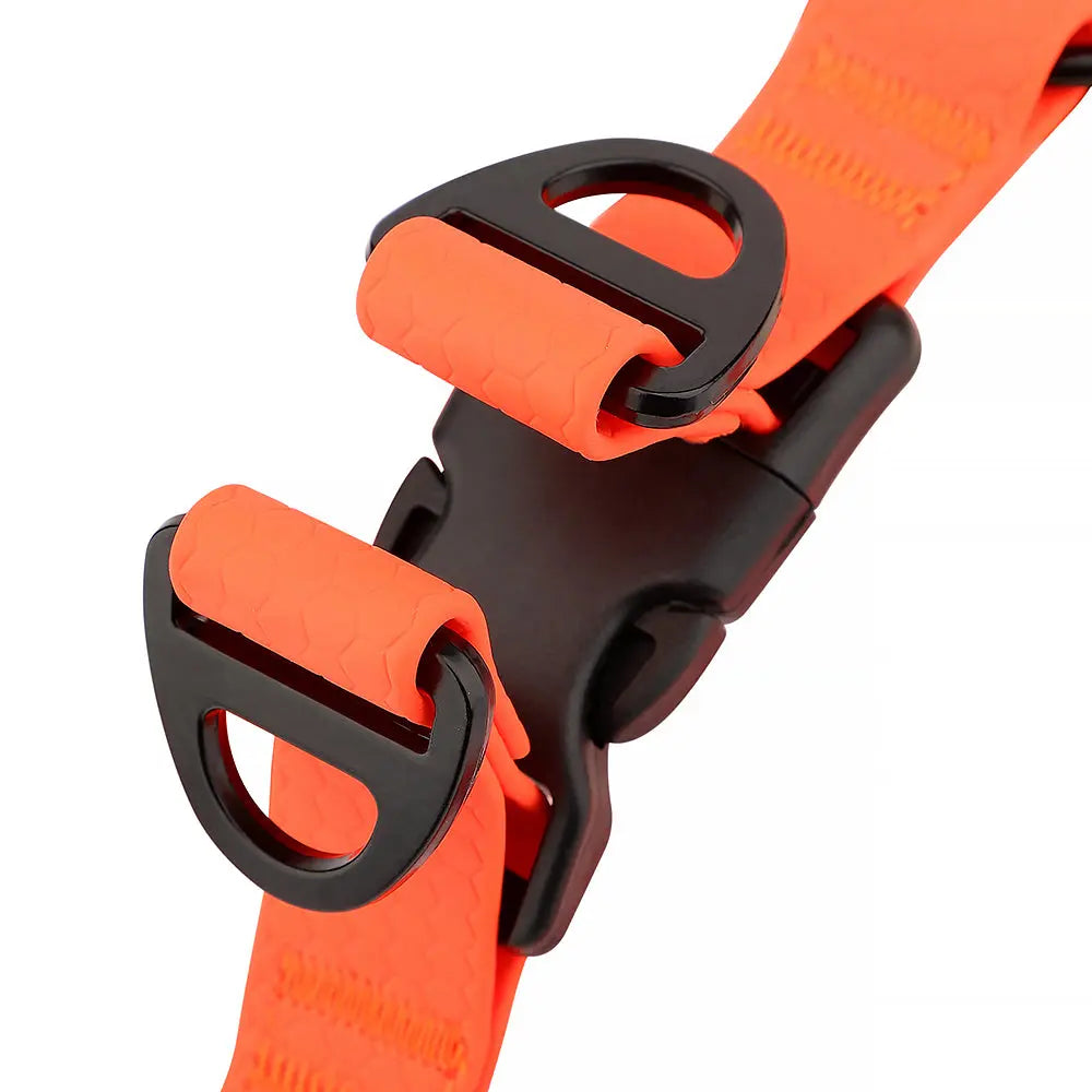 Detailed view of rust-resistant heavy-duty D-rings on high-visibility orange waterproof dog harness for leash attachment